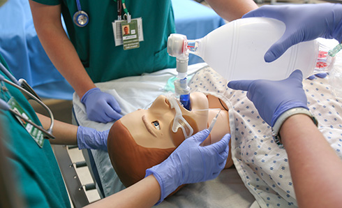 Highline College Respiratory Care program students training on a mannequin